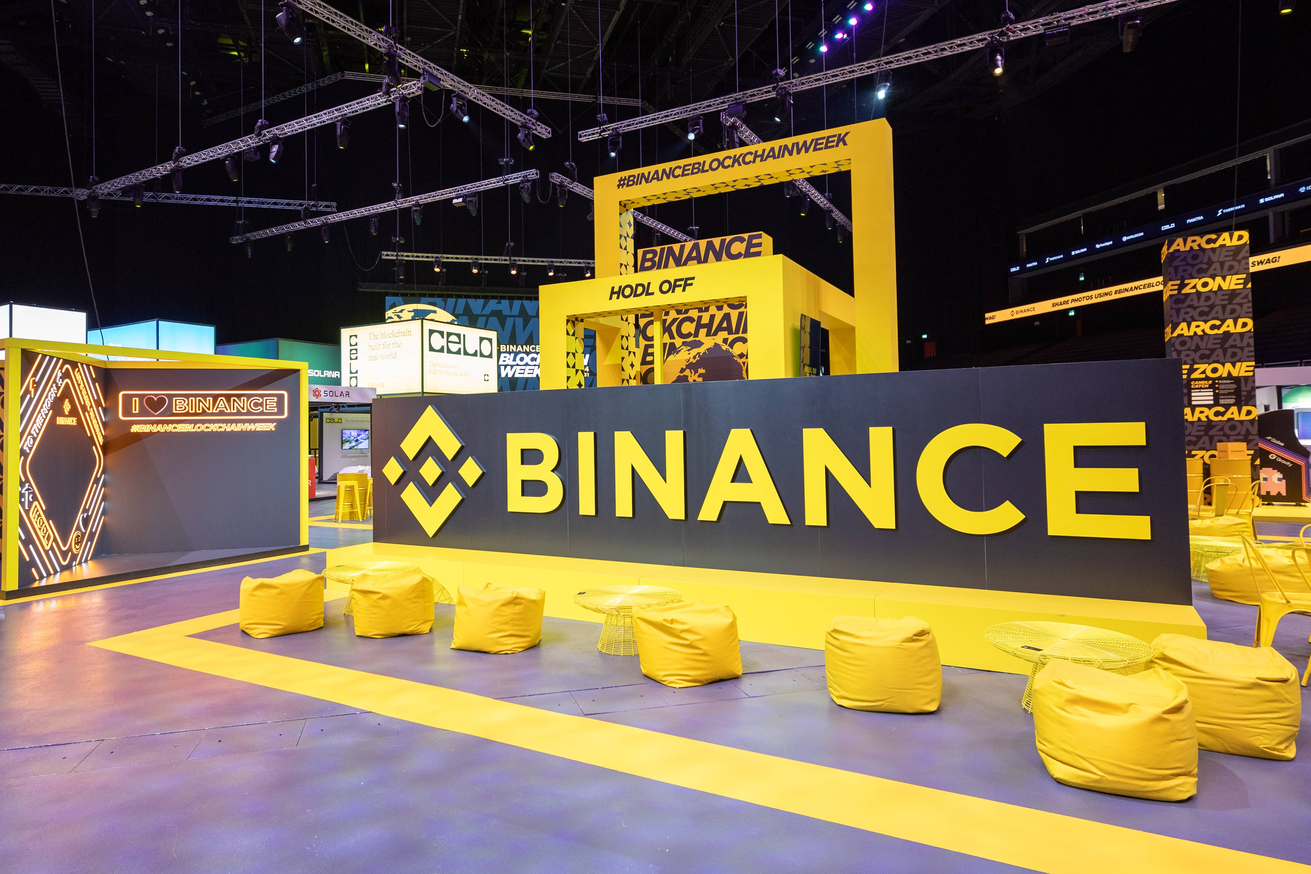 Binance Blockchain Week agenda event showcasing the Binance logo at a yellow-themed exhibition booth